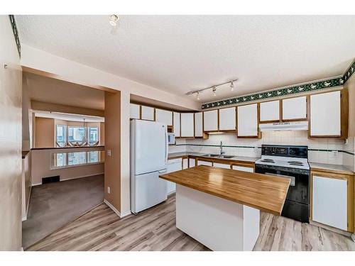 420 Hawkstone Manor Nw, Calgary, AB - Indoor Photo Showing Kitchen With Double Sink