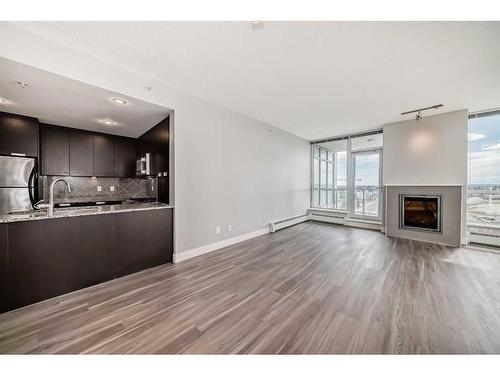1105-99 Spruce Place Sw, Calgary, AB - Indoor With Fireplace