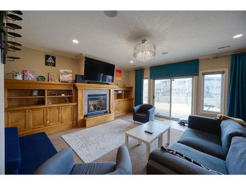 36 Coulee Park Sw, Calgary, AB - Indoor Photo Showing Living Room With Fireplace