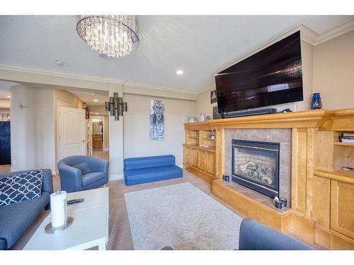 36 Coulee Park Sw, Calgary, AB - Indoor Photo Showing Living Room With Fireplace
