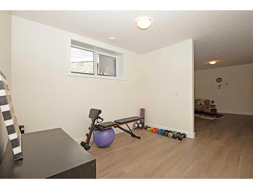 633 Country Meadows Close, Diamond Valley, AB - Indoor Photo Showing Gym Room