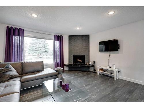 651 Willesden Drive Se, Calgary, AB - Indoor Photo Showing Living Room With Fireplace