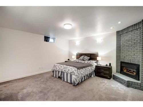 651 Willesden Drive Se, Calgary, AB - Indoor Photo Showing Bedroom With Fireplace