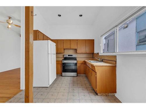 710 68 Avenue Sw, Calgary, AB - Indoor Photo Showing Kitchen With Double Sink