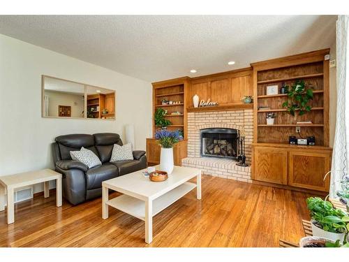 130 Hawkstone Drive Nw, Calgary, AB - Indoor Photo Showing Living Room With Fireplace