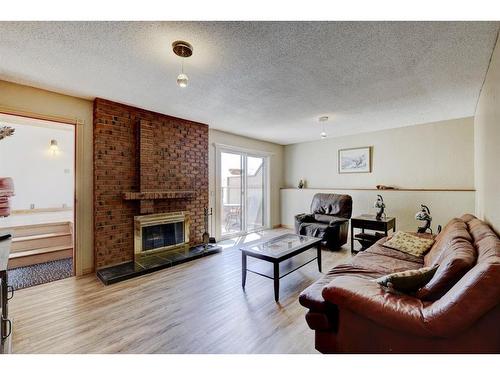 147 Strathcona Close Sw, Calgary, AB - Indoor Photo Showing Living Room With Fireplace