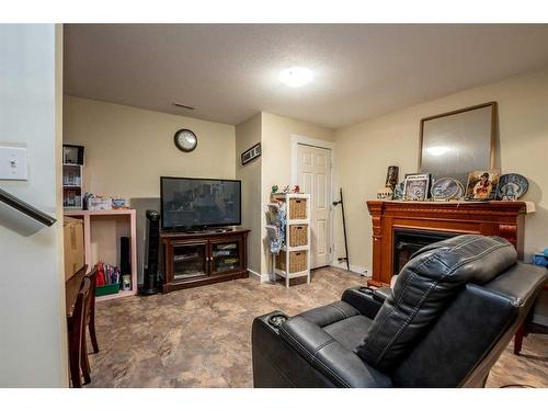 118 3 Avenue Se, High River, AB - Indoor Photo Showing Living Room With Fireplace