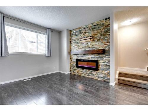 652 Copperpond Boulevard Se, Calgary, AB - Indoor Photo Showing Living Room With Fireplace