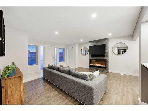 316 Ashley Crescent Se, Calgary, AB - Indoor Photo Showing Living Room With Fireplace