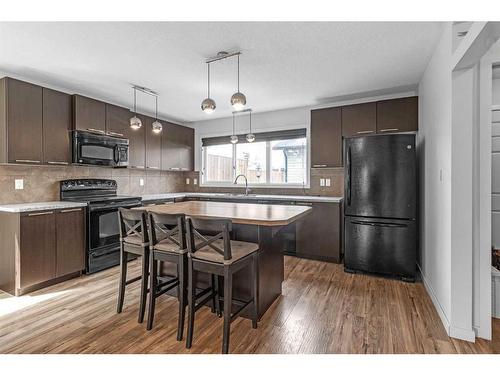 338 Sunset Common, Cochrane, AB - Indoor Photo Showing Kitchen With Upgraded Kitchen