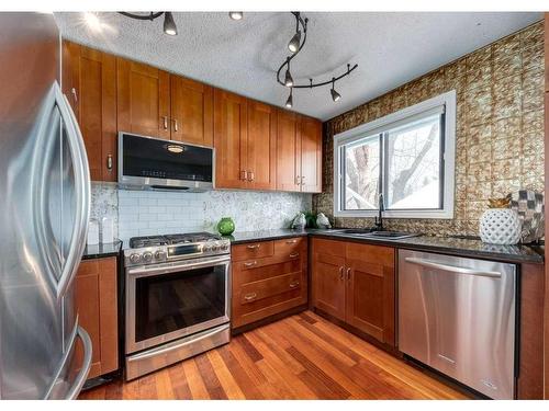 323 Woodside Circle Sw, Calgary, AB - Indoor Photo Showing Kitchen With Stainless Steel Kitchen With Double Sink