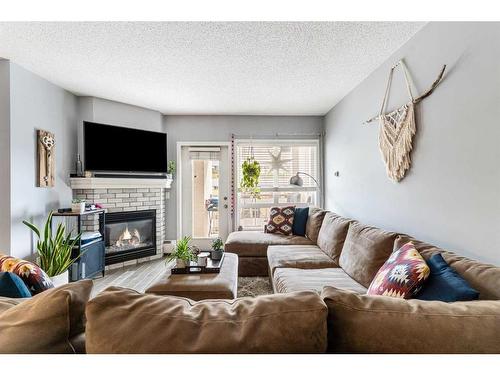 607-114 15 Avenue Sw, Calgary, AB - Indoor Photo Showing Living Room With Fireplace
