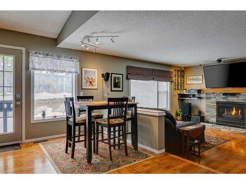 338 Millrise Drive Sw, Calgary, AB - Indoor Photo Showing Dining Room With Fireplace