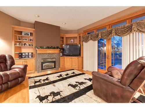 3001 10 Street, Didsbury, AB - Indoor Photo Showing Living Room With Fireplace