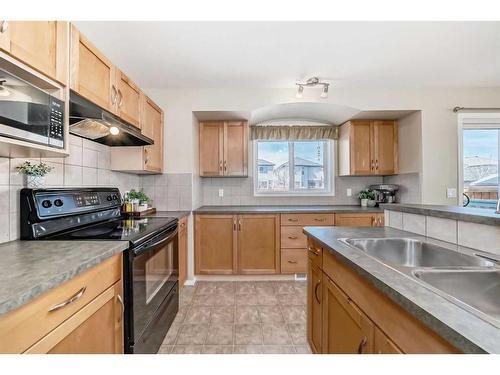 75 Bridlecrest Road Sw, Calgary, AB - Indoor Photo Showing Kitchen With Double Sink