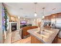 913 Cranston Drive Se, Calgary, AB  - Indoor Photo Showing Kitchen With Fireplace With Double Sink 