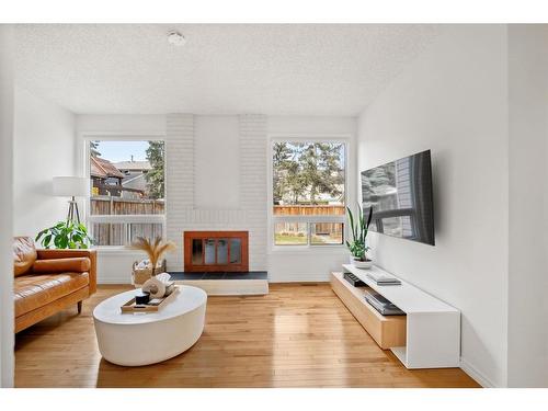 116 Stradwick Rise Sw, Calgary, AB - Indoor Photo Showing Living Room With Fireplace
