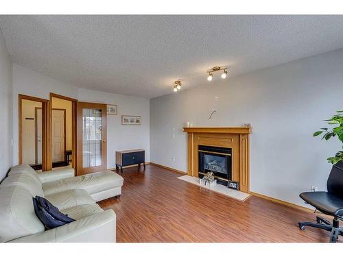 11460 Coventry Boulevard Ne, Calgary, AB - Indoor Photo Showing Living Room With Fireplace