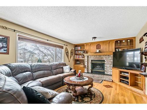 38 Crystalridge Way, Okotoks, AB - Indoor Photo Showing Living Room With Fireplace
