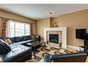 273 Cougartown Circle Sw, Calgary, AB  - Indoor Photo Showing Living Room With Fireplace 