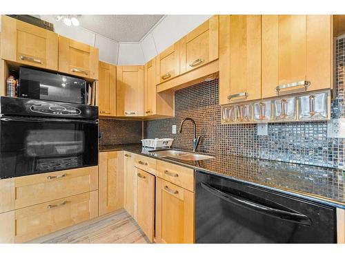 124-3219 56 Street Ne, Calgary, AB - Indoor Photo Showing Kitchen With Double Sink