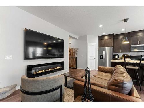 65 Howse Common Ne, Calgary, AB - Indoor Photo Showing Living Room With Fireplace