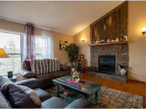 32169 Highway 760, Rural Mountain View County, AB - Indoor Photo Showing Living Room With Fireplace