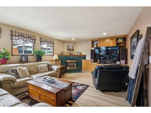 44 Woodbrook Place Sw, Calgary, AB - Indoor Photo Showing Living Room With Fireplace