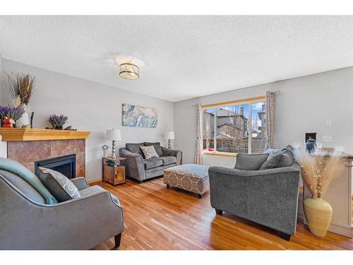 63 Brightondale Close Se, Calgary, AB - Indoor Photo Showing Living Room With Fireplace