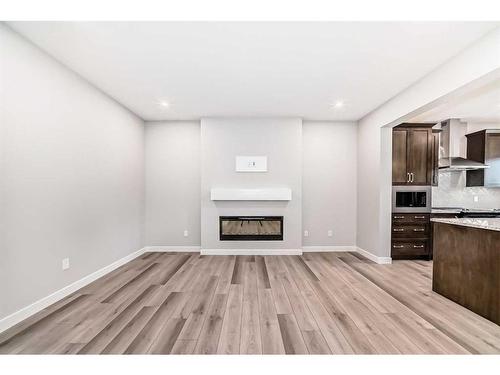 612 Baywater Manor Sw, Airdrie, AB - Indoor With Fireplace