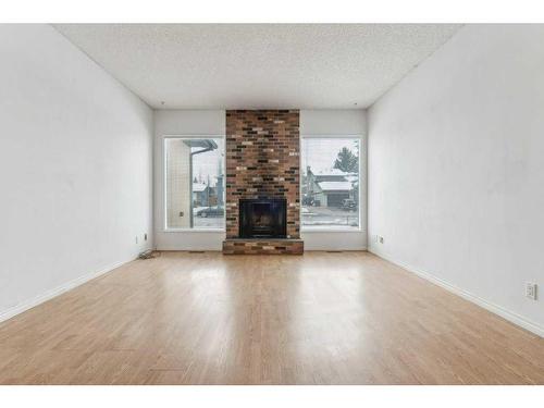 15123 Deer Run Drive Se, Calgary, AB - Indoor Photo Showing Living Room With Fireplace
