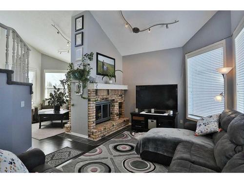 637 Woodbine Boulevard Sw, Calgary, AB - Indoor Photo Showing Living Room With Fireplace