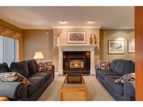 23 Prominence Point Sw, Calgary, AB - Indoor Photo Showing Living Room With Fireplace