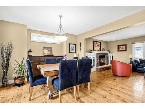 2715 48 Avenue Nw, Calgary, AB - Indoor Photo Showing Dining Room With Fireplace