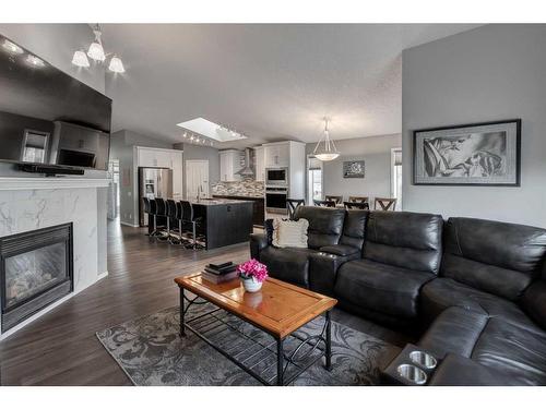 115 Bow Ridge Crescent, Cochrane, AB - Indoor Photo Showing Living Room With Fireplace