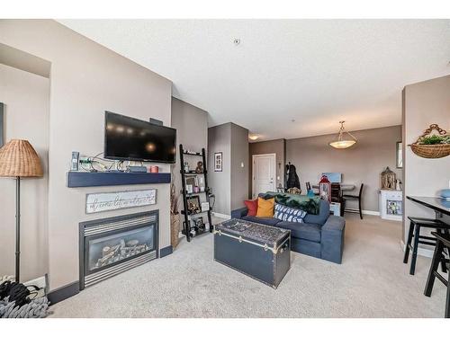 205-88 Arbour Lake Road Nw, Calgary, AB - Indoor Photo Showing Living Room With Fireplace