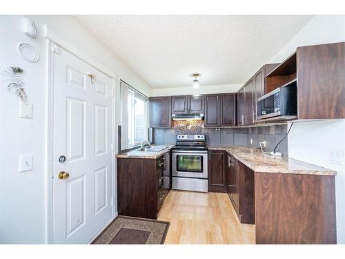 85 Martinbrook Road Ne, Calgary, AB - Indoor Photo Showing Kitchen With Double Sink