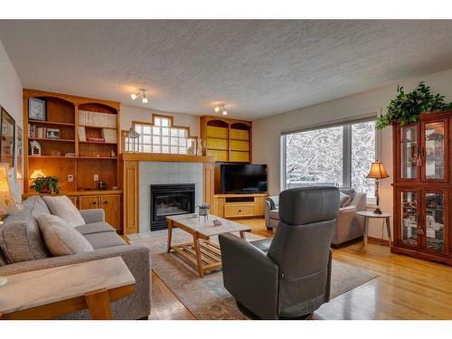 106 Arbour Ridge Heights Nw, Calgary, AB - Indoor Photo Showing Living Room With Fireplace