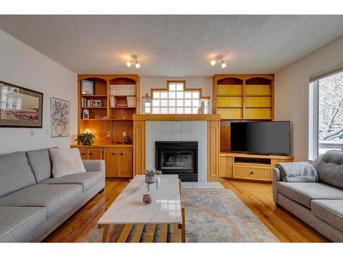106 Arbour Ridge Heights Nw, Calgary, AB - Indoor Photo Showing Living Room With Fireplace