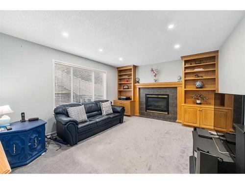7830 Springbank Way Sw, Calgary, AB - Indoor Photo Showing Living Room With Fireplace