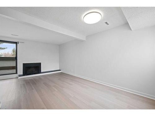 411-2520 Palliser Drive Sw, Calgary, AB - Indoor With Fireplace