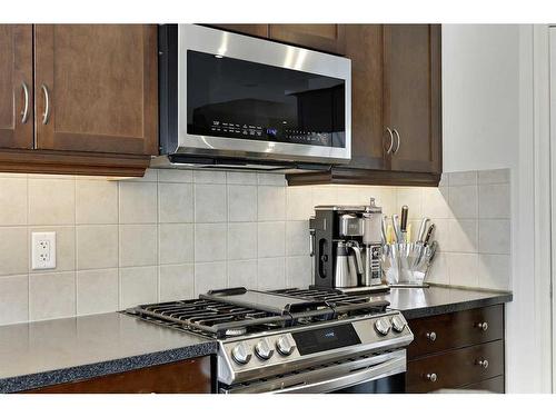 64 Reunion Close Nw, Airdrie, AB - Indoor Photo Showing Kitchen With Upgraded Kitchen