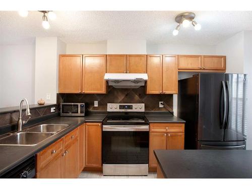 35 Toscana Gardens Nw, Calgary, AB - Indoor Photo Showing Kitchen With Double Sink