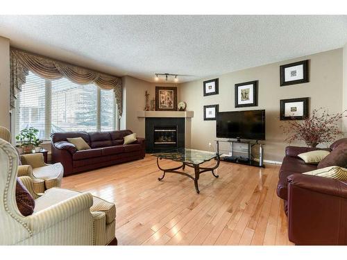 335 Cresthaven Place Sw, Calgary, AB - Indoor Photo Showing Living Room With Fireplace