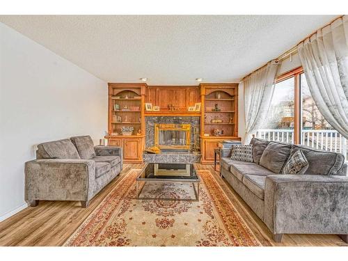 8328 Edgevalley Drive Nw, Calgary, AB - Indoor Photo Showing Living Room With Fireplace