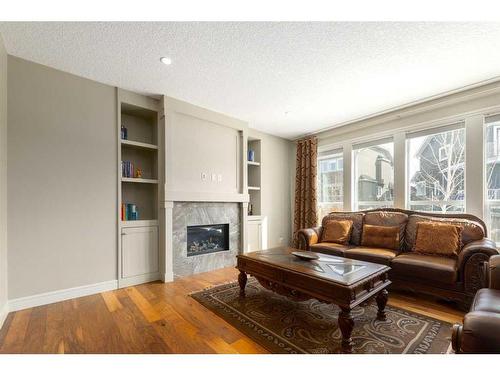 210 Aspen Stone Way Sw, Calgary, AB - Indoor Photo Showing Living Room With Fireplace