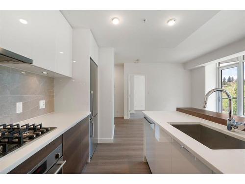 210-138 Waterfront Court Sw, Calgary, AB - Indoor Photo Showing Kitchen With Upgraded Kitchen