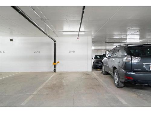 210-138 Waterfront Court Sw, Calgary, AB - Indoor Photo Showing Garage