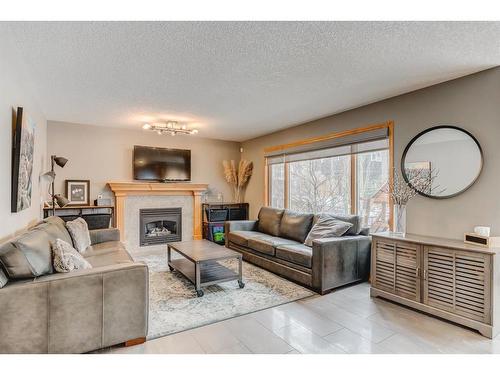 258 Arbour Vista Road Nw, Calgary, AB - Indoor Photo Showing Living Room With Fireplace