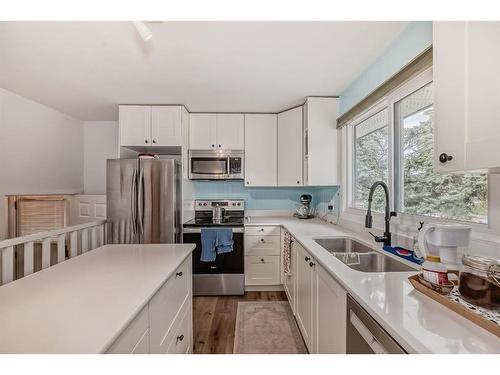 60 Glacier Drive Sw, Calgary, AB - Indoor Photo Showing Kitchen With Double Sink